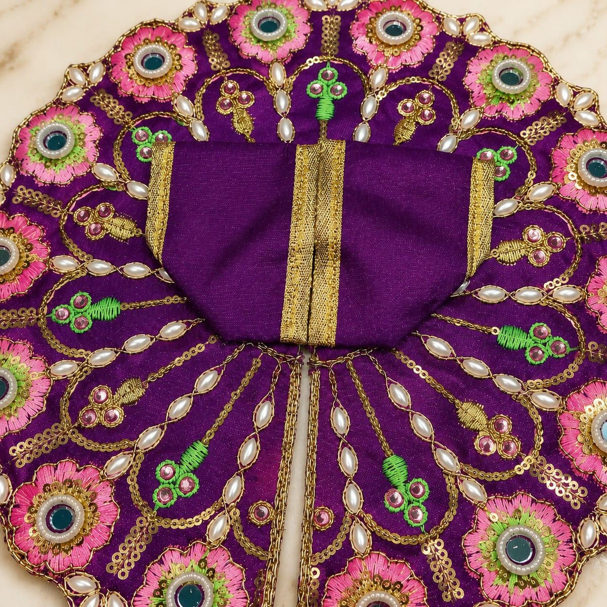 Purple Krishna Ji Poshak dress with pink flowers and pearl embellishments